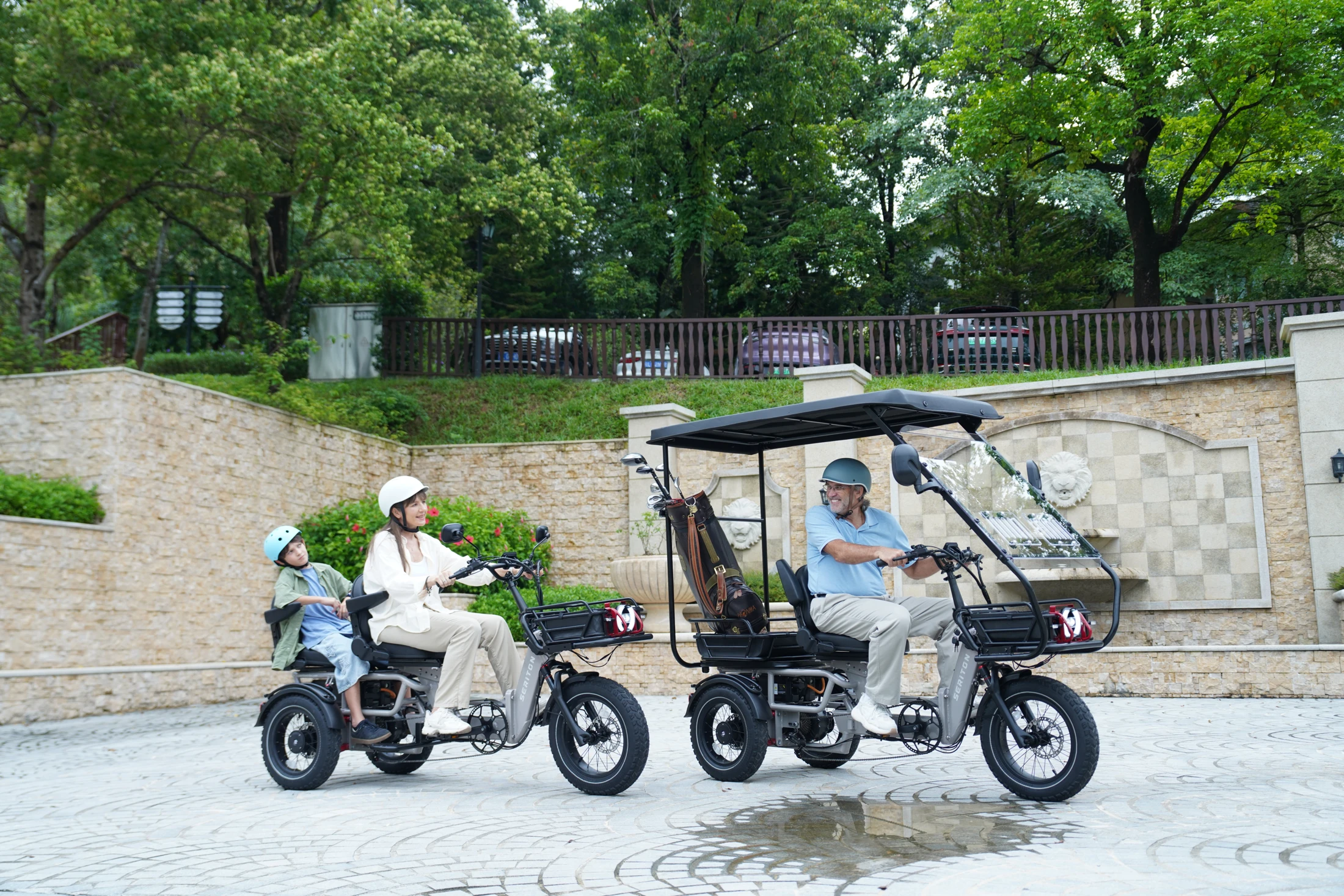 Two SERITON electric trikes with riders, passenger seating and canopy