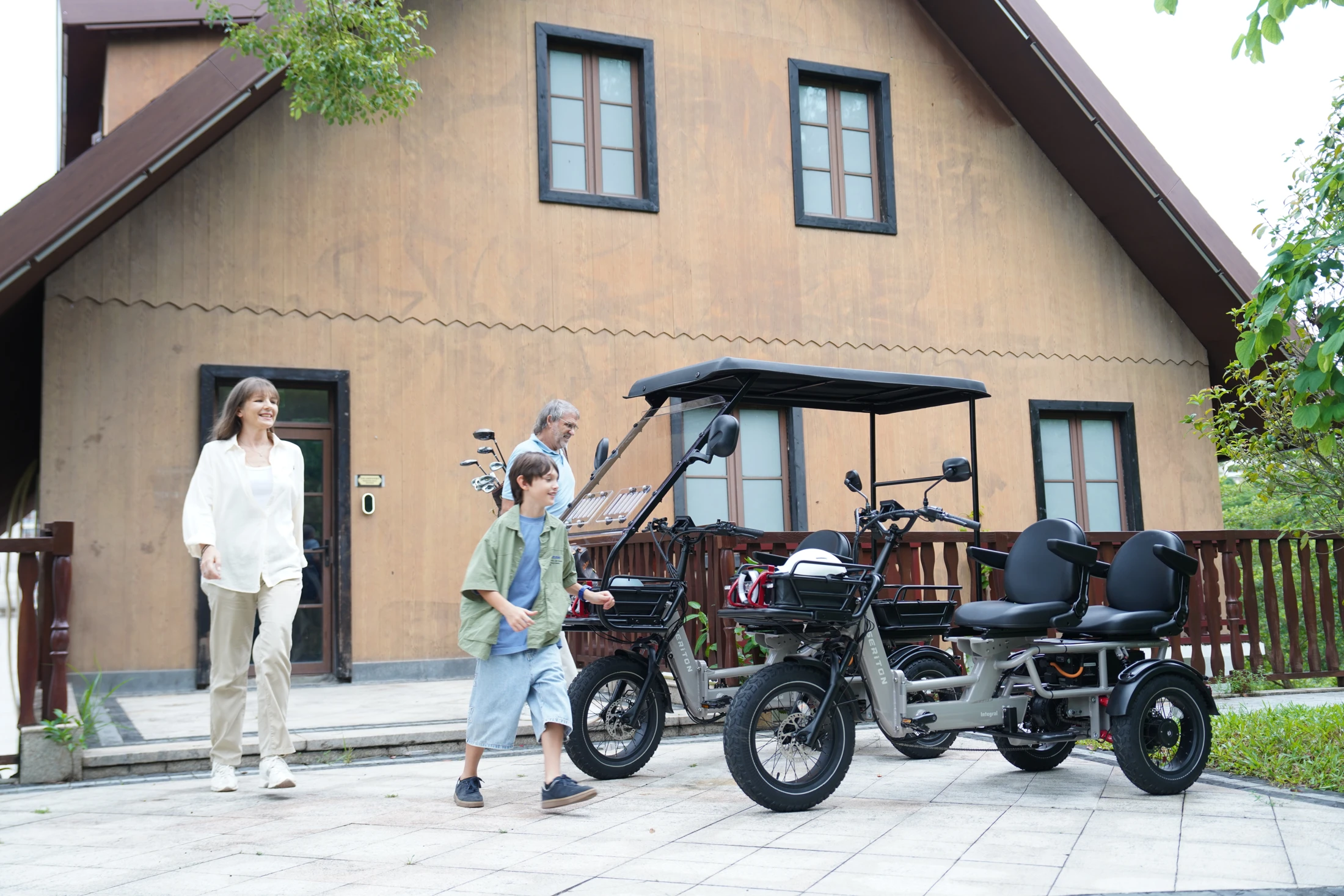 Family beside SERITON trikes with passenger seating and an optional canopy
